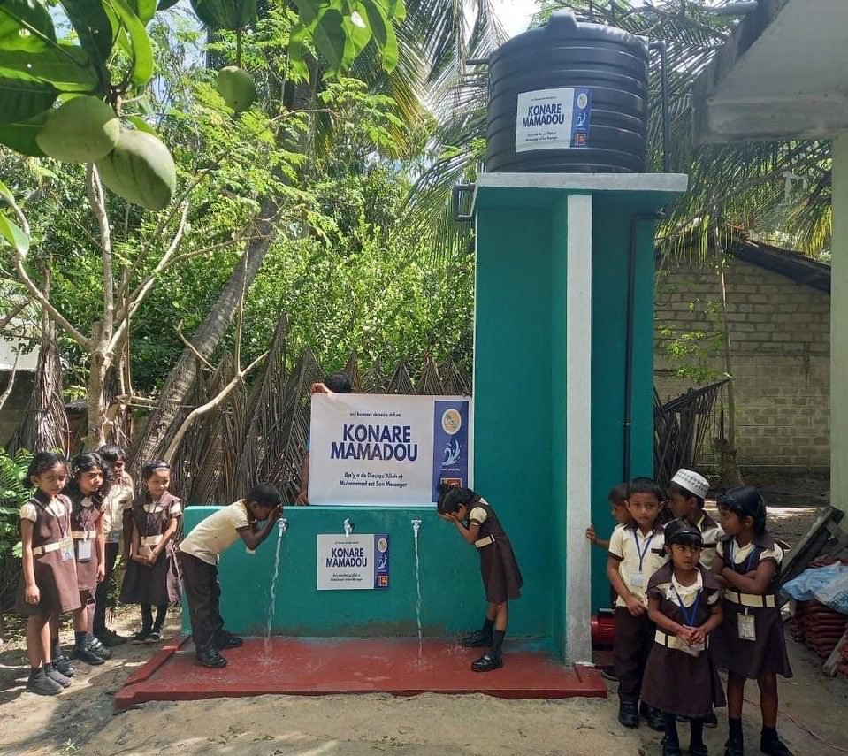 Children drinking from a water fountain.