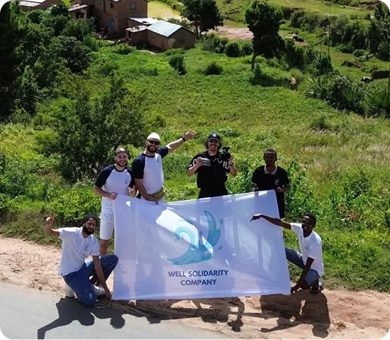 Group holding a Well Solidarity Company banner.
