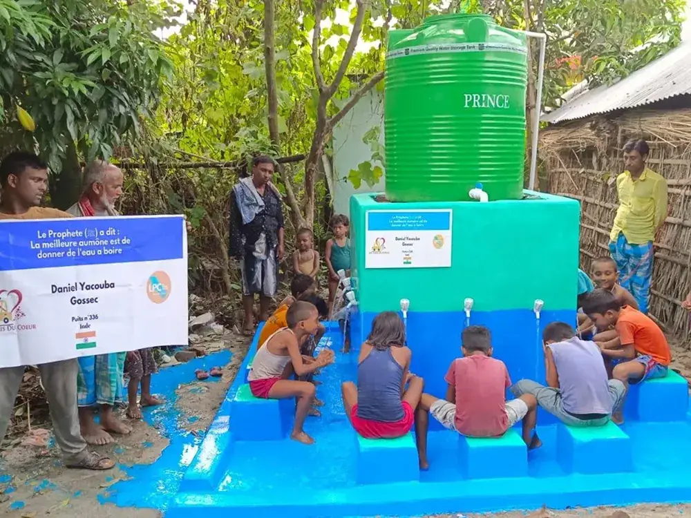 Children drinking from a community fountain.