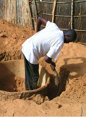 Person digging soil with a shovel.