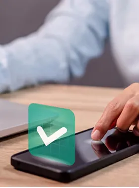 Hand touching a smartphone with a verification icon.